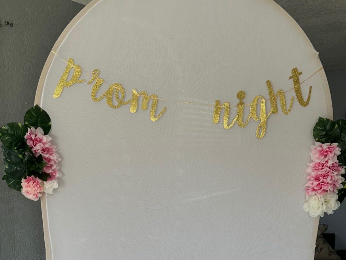 Prom night photo backdrop decorated with flowers