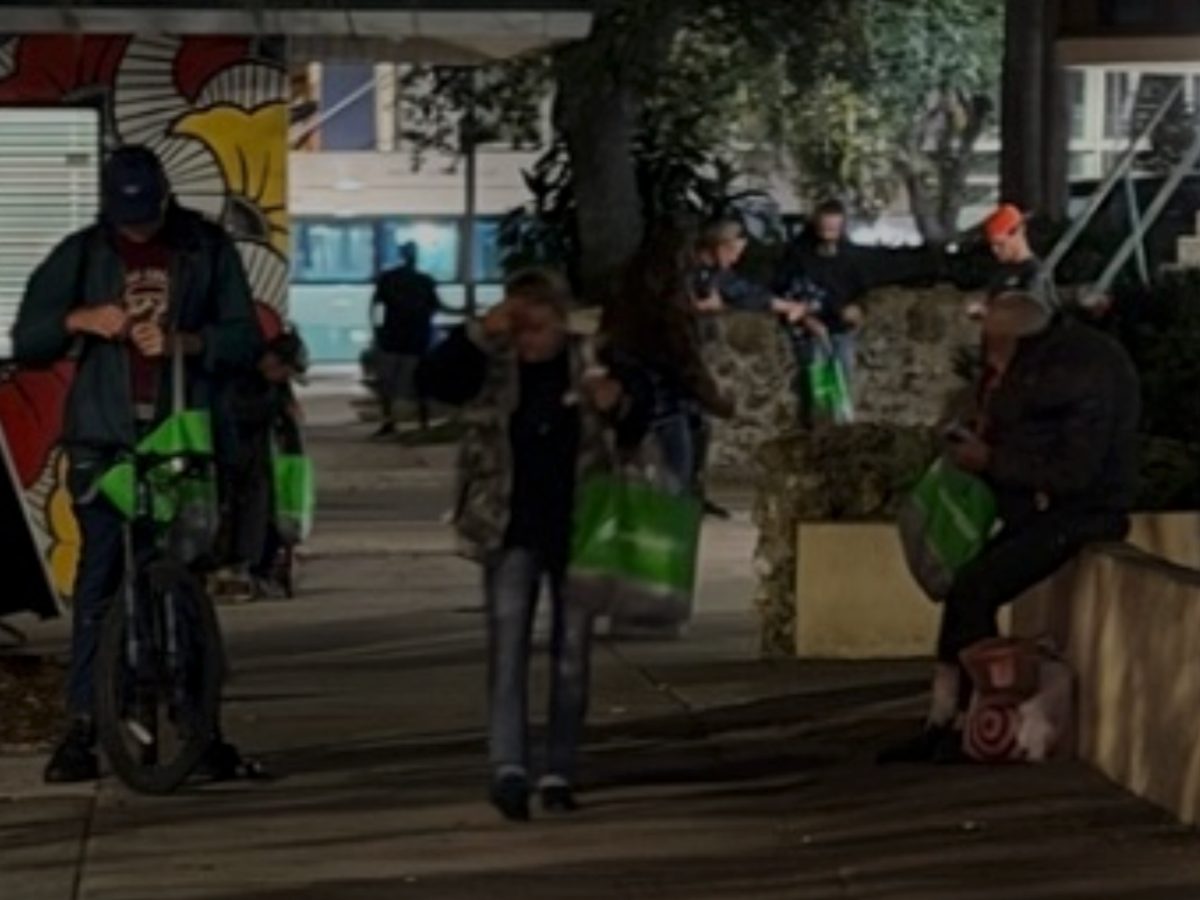 Outreach team handing out supply bags at night