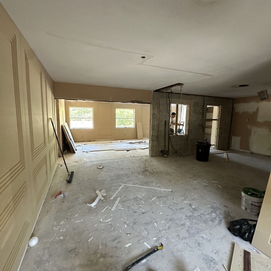 Crew finishing walls in an open room