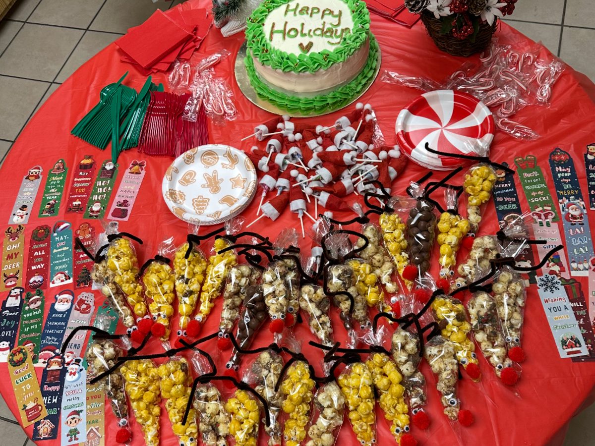 Holiday party table with cake and treats for students