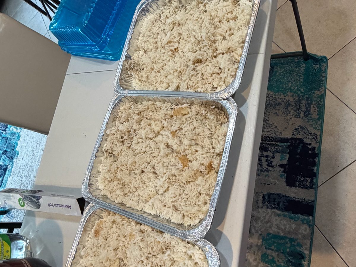 Trays of seasoned rice prepared for families