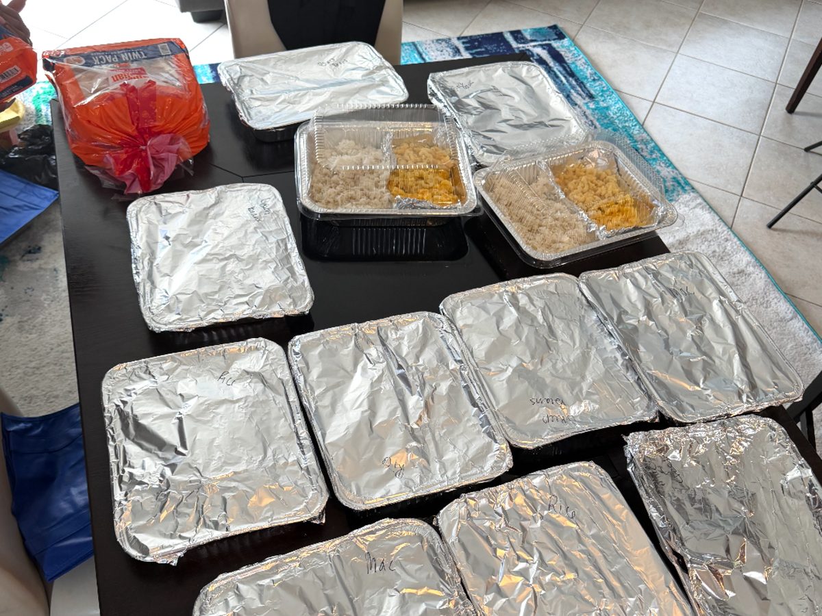 Covered trays of Thanksgiving sides ready to go