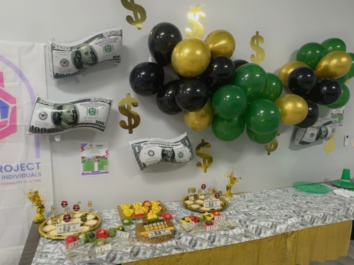 Money-themed financial literacy celebration with the C.A.L.I. banner
